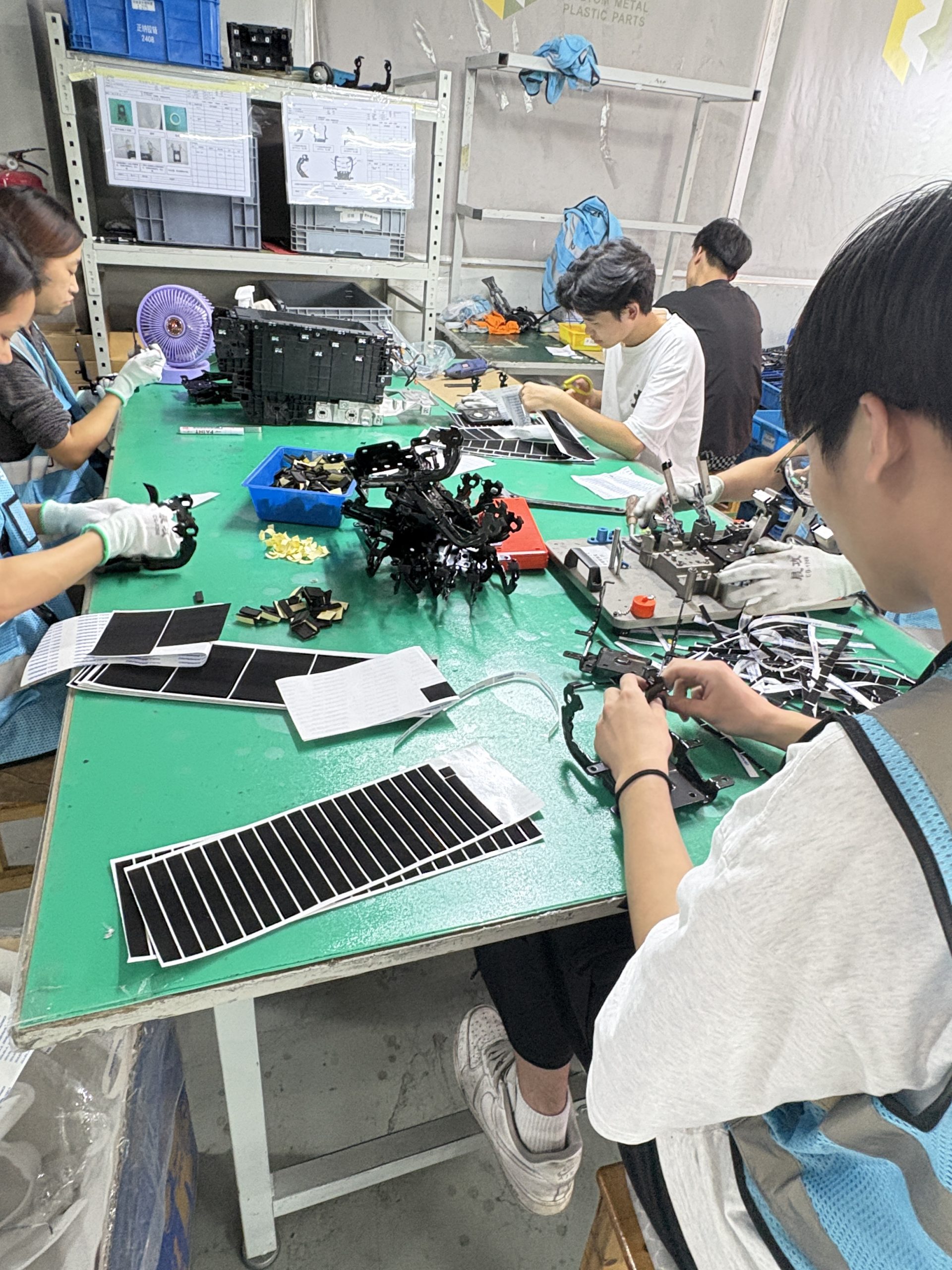 Workers assembling precision components